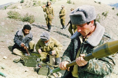 GULABIRD, AZERBAIJAN - OCTOBER 18:  Azeri soldiers feed ammunition belts while another assembles a rocket as they prepare themselves for their next fighting encounter in the village of Gulabird in the southern part of the embattled Armenian enclave of Nagorno Karabakh 18 October 1992.  (Photo credit should read MAXIMOV/AFP/Getty Images)